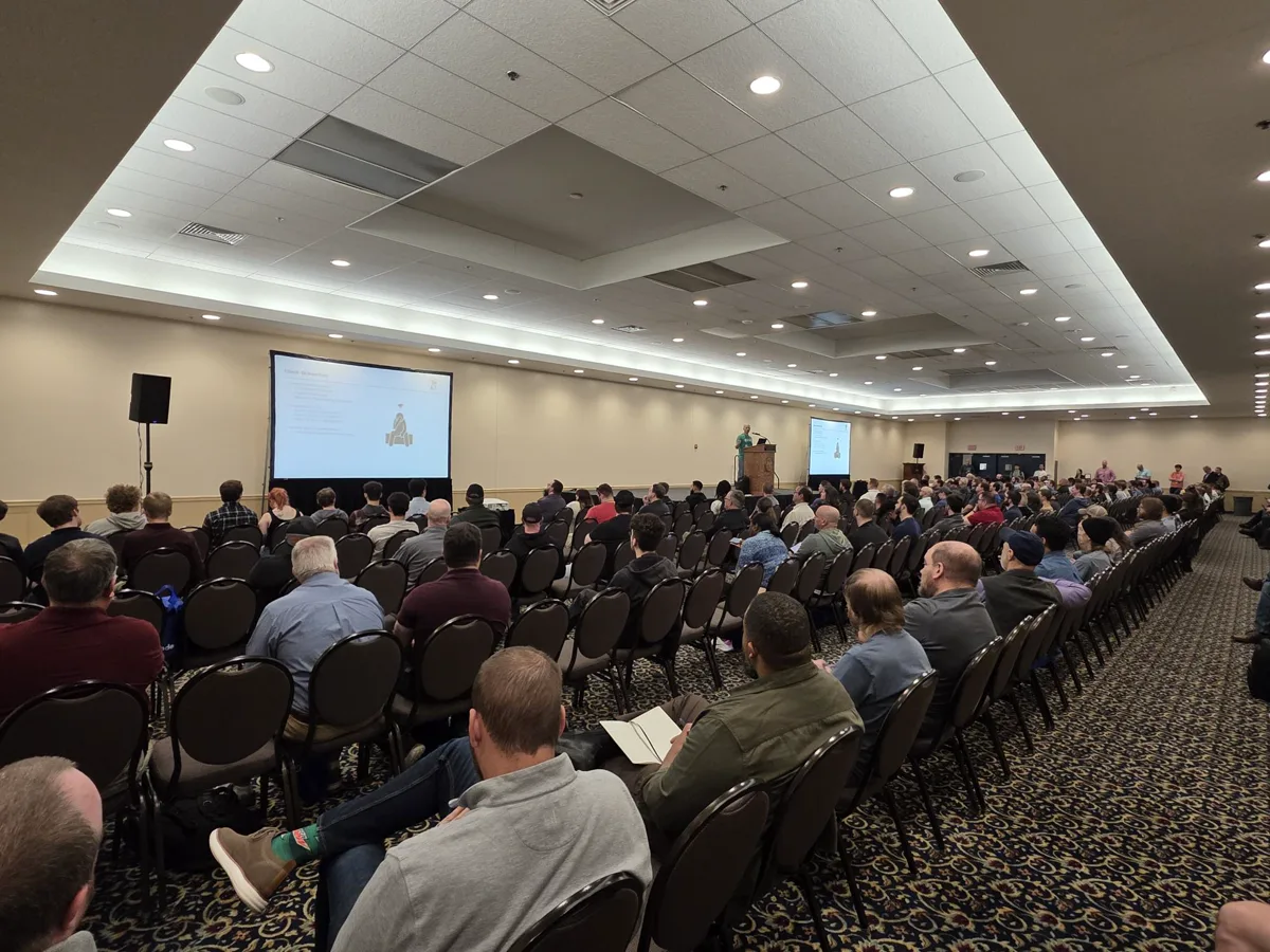 Chris Traynor presenting Pentest Pains on stage at BSides Harrisburg 2025