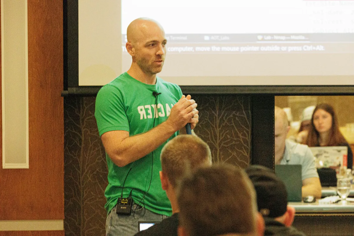Chris Traynor teaching hands-on offensive security training to students at a conference